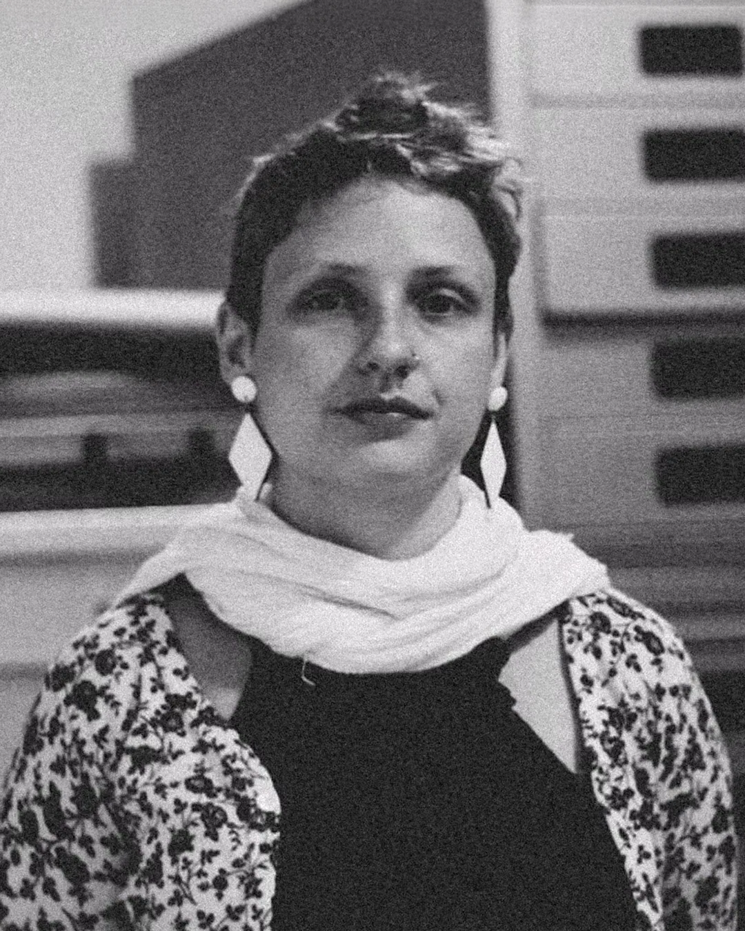 Portrait of Marina Nabuco inside an archive, surrounded by drawers and framed works.